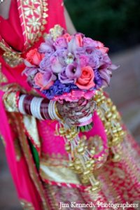 Indian Bride holding a beautiful flower bouquet at her wedding organized by Wedding Event Management Company Kiyoh