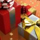 Gifts in boxes wrapped in red coloured and silver coloured wrappers and golden coloured bow tiep up over them.