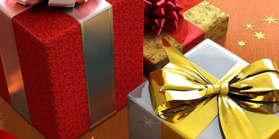 Gifts in boxes wrapped in red coloured and silver coloured wrappers and golden coloured bow tiep up over them.