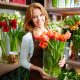 A Beautiful Smiling Woman Standing With A Flower Bouquet In A Florist Shop Which Representing Floral Design Industry.