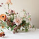 A set of colourful flowers kept in the flower vase on the table.