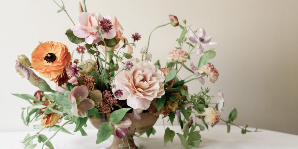 A set of colourful flowers kept in the flower vase on the table.