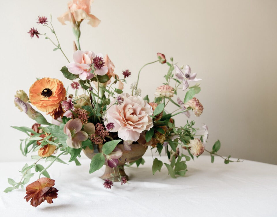 A set of colourful flowers kept in the flower vase on the table.