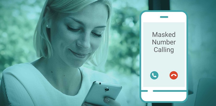 A lady is operating her smartphone while a graphical image of a smartphone with the text "Masked Number Calling" is kept against her.